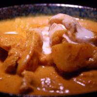 45 Chicken Massaman Curry · Chunk of chicken with potatoes and peanuts simmered in Thai massaman curry and coconut milk.