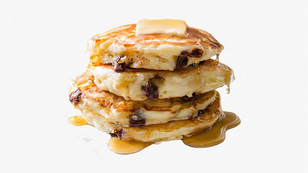 Chocolate Chip Pancakes · Three fluffy pancakes topped with chocolate chips, and served with syrup and powdered sugar.