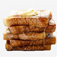 French Toast · Two slices of thick, egg-washed cinnamon bread served with syrup and powdered sugar.