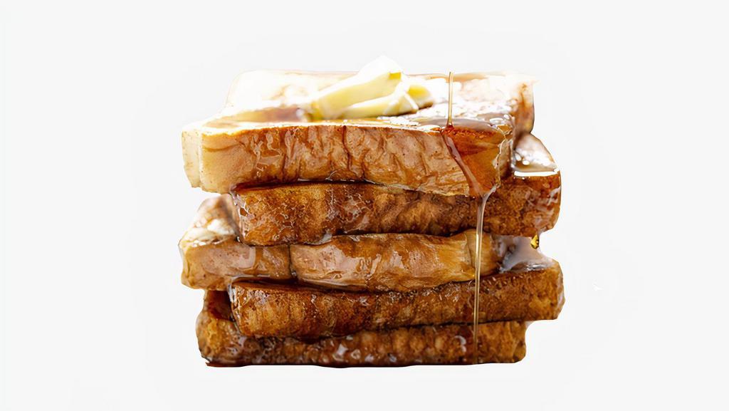 French Toast · Two slices of thick, egg-washed cinnamon bread served with syrup and powdered sugar.