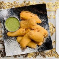 Mirchi Bajji · Fresh-cut Serrano chillies loosely battered with
gram flour, spices and deep fried