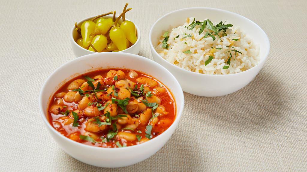 Bean Stew (V) · Traditional Turkish bean stew cooked with onion and pepper paste. Served with jasmine rice with gluten-free orzo and pickled pepper. Gluten-free. Vegan.