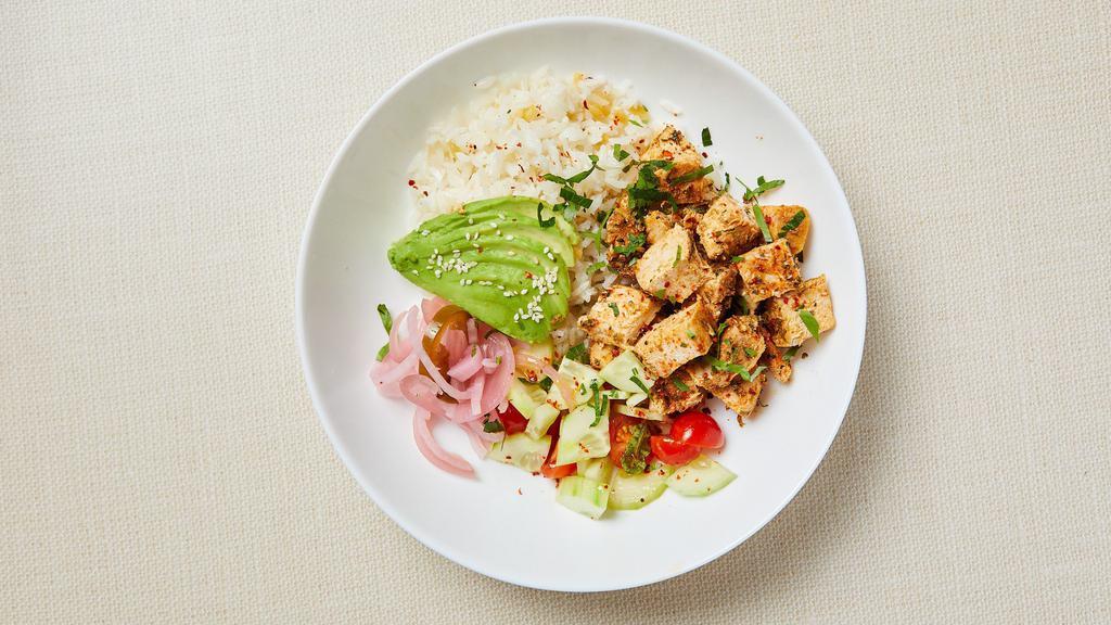 Mediterranean Chicken Rice Bowl · Roasted organic spicy chicken kebab, jasmine rice with gluten free orzo, grape tomato, cucumber, parsley, avocado and pickled red onion. Served with spicy yogurt sauce. Gluten-free. Dairy-free (no yogurt sauce).