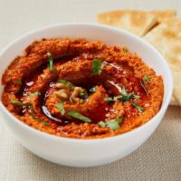 Muhammara (Red Pepper Dip) · Homemade roasted red pepper dip with garlic, tahini, pomegranate sauce and walnut. Served wi...