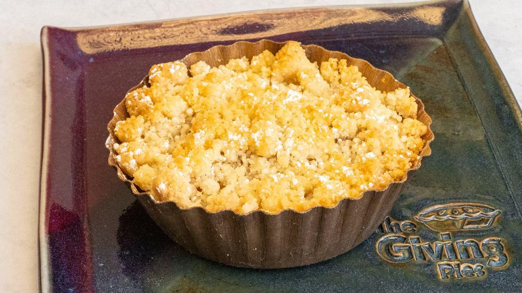 Peach Pie · Vegetarian. Peaches, a hint of cinnamon and our signature almond crumble topping! Freezer friendly. Contains: wheat, butter, almonds.