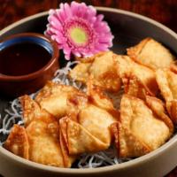 Crispy Crab Wontons · Crab meat blended with cream cheese, green onion, water chestnut, and sweet chili sauce frie...