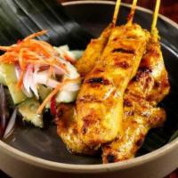 Chicken Satay · Grilled marinated chicken with Thai curry powder. Served with peanut sauce and fresh cucumbe...