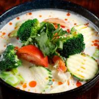 Tom Kha · Fresh coconut soup with lemongrass, kaffir lime leaf, mushroom, onion, and tomato.