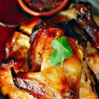 Barbeque Chicken · Half-grilled chicken marinated with coconut milk and Thai spices. Served with sticky rice an...