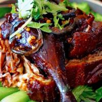 Honey Roasted Duck · Roasted duck with bone cooked in honey glaze. Served over steamed baby bok choy with sweet s...