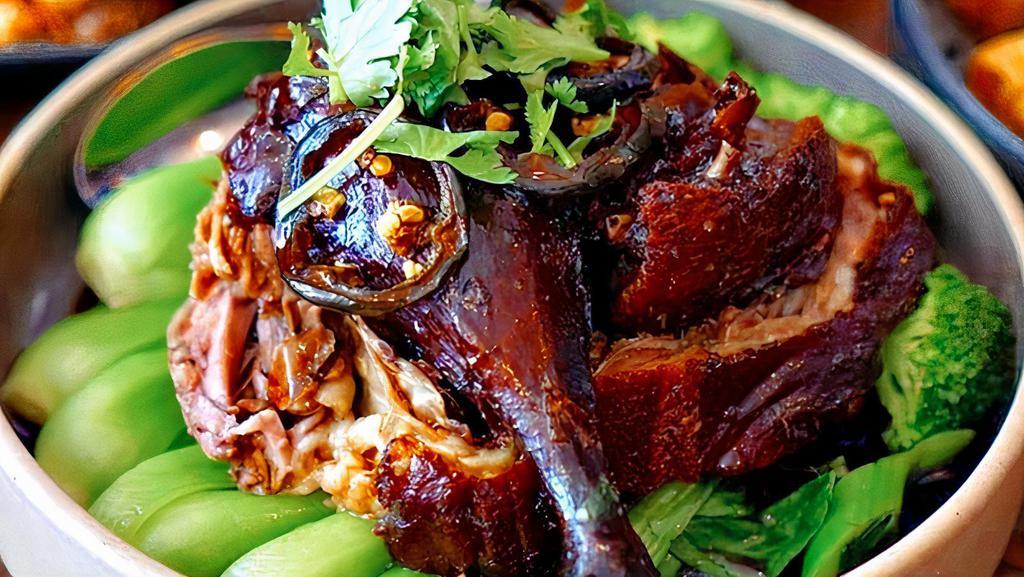 Honey Roasted Duck · Roasted duck with bone cooked in honey glaze. Served over steamed baby bok choy with sweet spicy black soy dipping sauce.