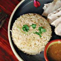 Khao Mun Gai · Steamed capon in ginger flavored rice, poach chicken served with spicy fresh chili, ginger, ...