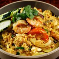 Pineapple Fried Rice · Fried rice with egg, onion, green onion, cashew nut, raisins, pineapple, chicken, and prawns.