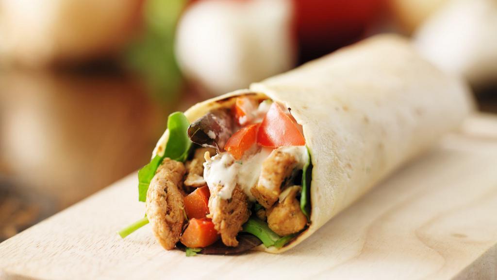 The Chicken Shawarma Wrap · Sizzling strips of chicken shawarma, lettuce, tomatoes, onions, tzatziki and tahini sauce wrapped in lavash bread.
