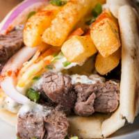 The Philly Gyro Wrap · Exotic philly wrap with slices of roasted lamb and beef meat, sautéed bell peppers, grilled ...