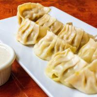 Chicken Momo · Eight pieces. Steamed dumplings filled with minced chicken, onion, garlic, ginger, cilantro ...