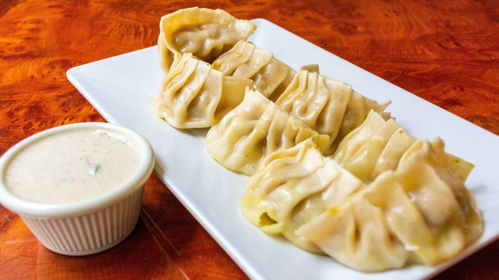 Chicken Momo (8 Pcs.) · Homemade dumpling filled with ground chicken meat cabbage, onion, scallion, cilantro, garlic & ginger choice of steamed, fried, or gravy.