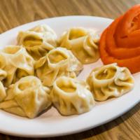Vegetable Momo · Eight pieces. Steamed dumplings filled with minced cabbage, cauliflower, spinach, cashew nut...