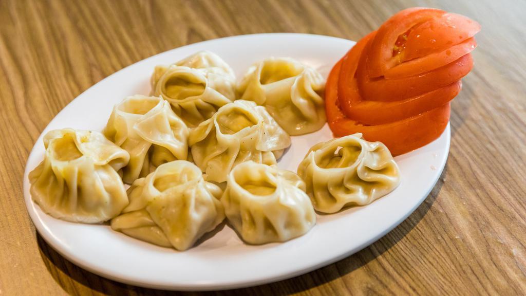 Veg Momo (8 Pcs.) · Vegetable dumpling filled with mixed vegetables mashed potatoes and spices. choice of steamed, fried, or gravy.