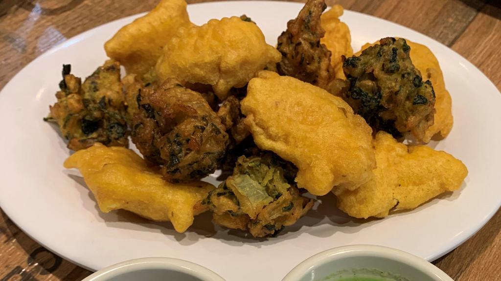 Vegetable Pakora · Vegan. Five pieces. Cabbage, onion, potato mixed golden fried vegetable served with mint sauce.