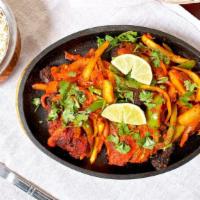 Chicken Tandoori · Chicken leg quarter marinated in yogurt and spices, broiled in the tandoor oven. Served sizz...