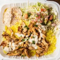 Chick's Shawarma Plate · Chicken shawarma served with hummus, saffron rice, and salad on the side.