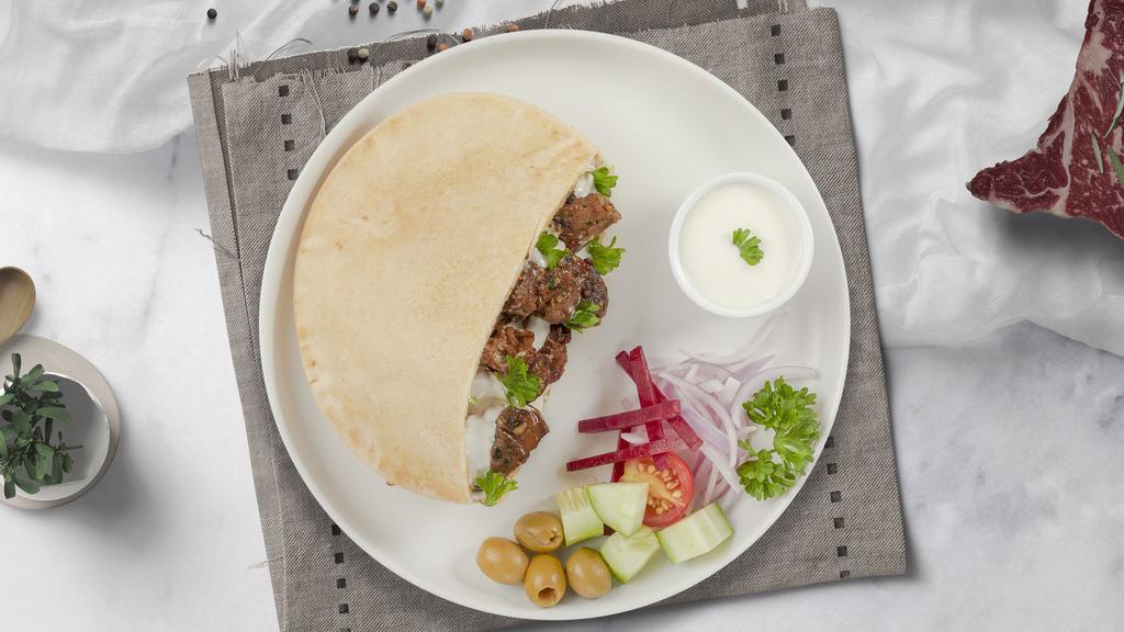 Lala Lamb Shawarma Wrap · (Halal) Lamb, hummus, lettuce, minced salad, pickle, and tahini sauce.