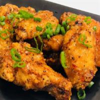 Vietnamese Sticky Wings · Mild spicy. Fried chicken wings caramelized in fish sauce, black pepper, Thai chili, and sca...