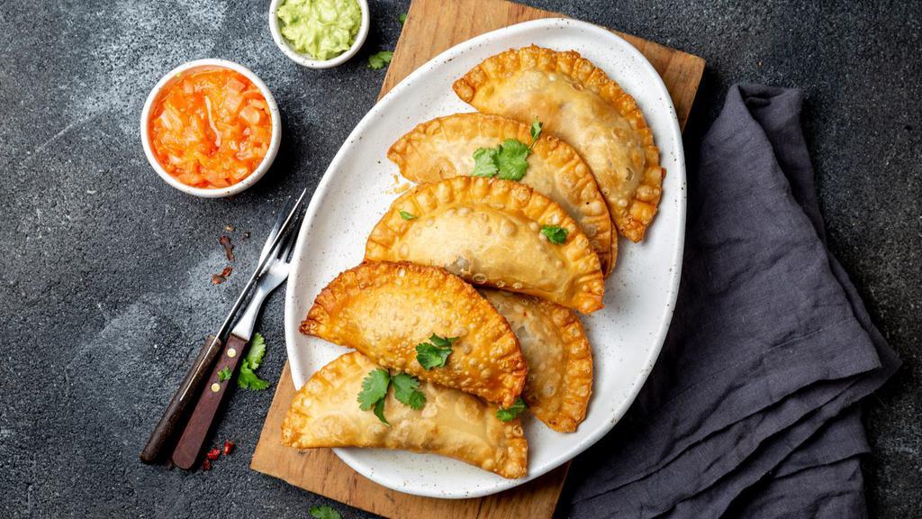 Empanadas · Fried corn dough, filled with customer's choice of filling. Served with tomato sauce and marinated cabbage.