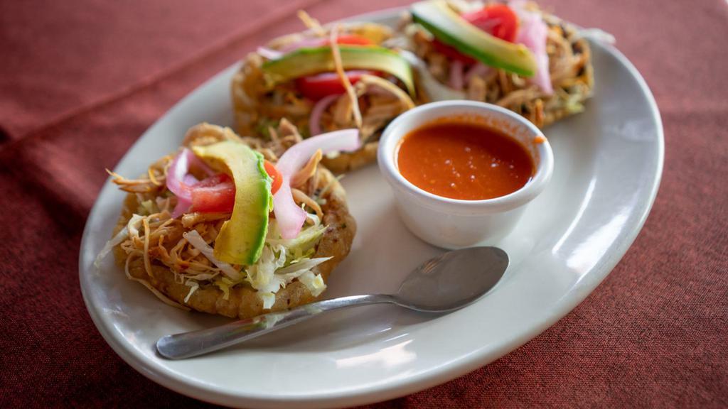 Salbutes · Fried corn tortilla, served with lettuce, marinated cabbage, tomato, marinated onion, and customer's choice of meat.