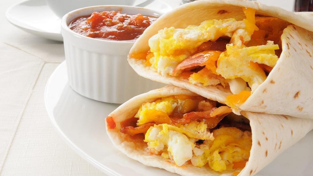 Bacon Breakfast Burrito · Crispy bacon burrito served with fresh eggs, cheese, and home fries.