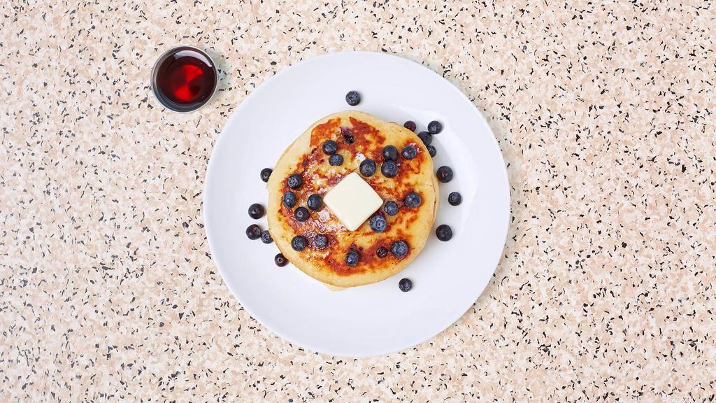 Blueberry Pancakes · Two fluffy blueberry pancakes with syrup and butter.