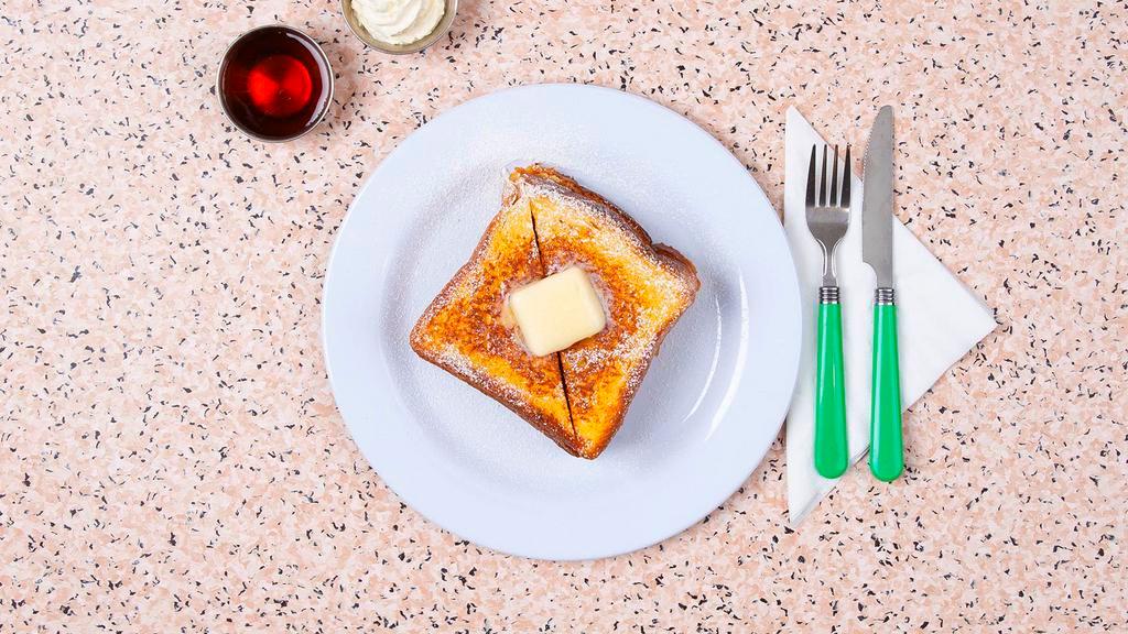 French Toast · Two thick slices of egg-washed cinnamon toast with syrup.