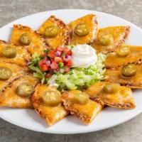 Classic Nachos · Shredded cheese, black beans, jalapeños, Skillet Queso with beef. Served with pico & sour cr...