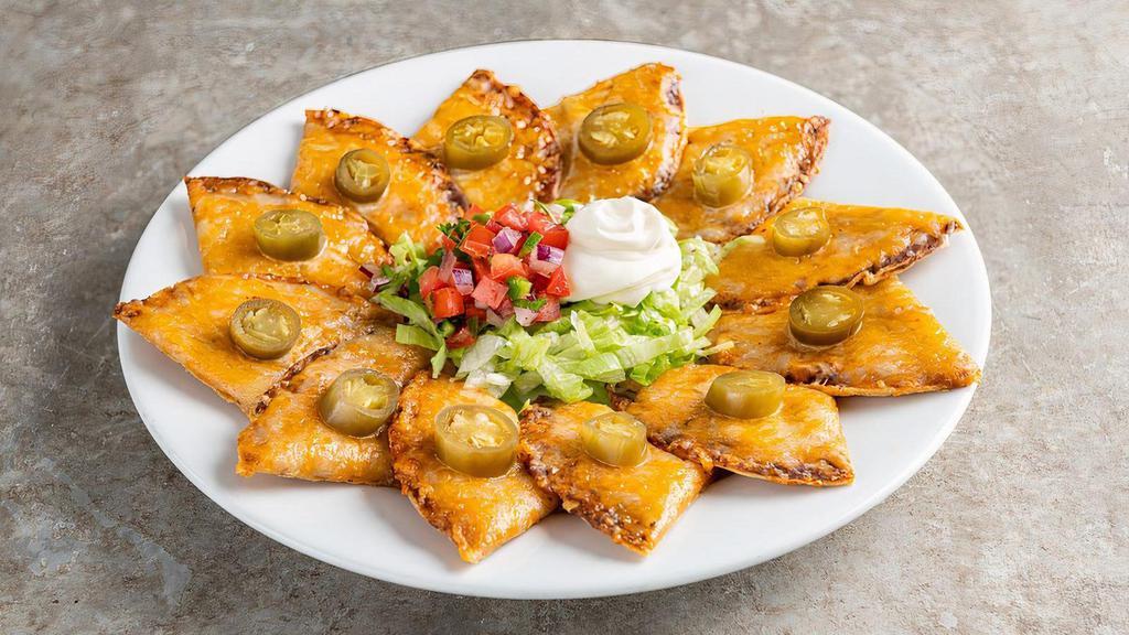 Classic Nachos · Shredded cheese, black beans, jalapeños, Skillet Queso with beef. Served with pico & sour cream.