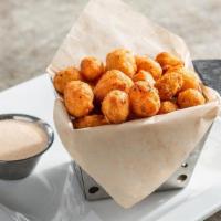 Crispy Cheddar Bites · White and yellow Wisconsin cheese curds topped with chile spices. Served with ancho-chile ra...