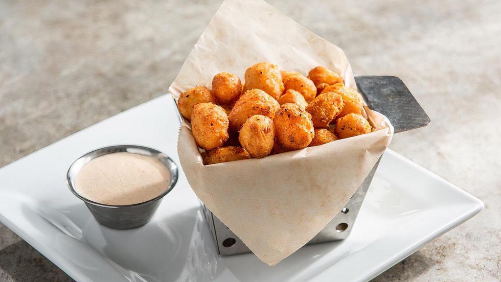 Crispy Cheddar Bites · White and yellow Wisconsin cheese curds topped with chile spices. Served with ancho-chile ranch.