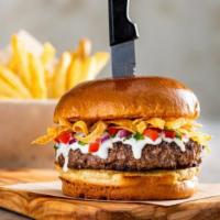 Queso Burger* · Say “cheese!” This half-pound patty comes smothered in white queso, crunchy tortilla strips ...