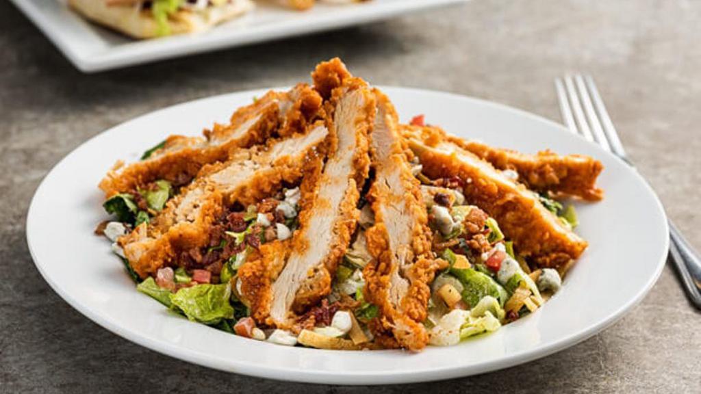 Boneless Buffalo Chicken Salad · Hand-breaded crispy chicken tossed in spicy Buffalo sauce, bacon, bleu cheese crumbles, pico, tortilla strips with house-made ranch.