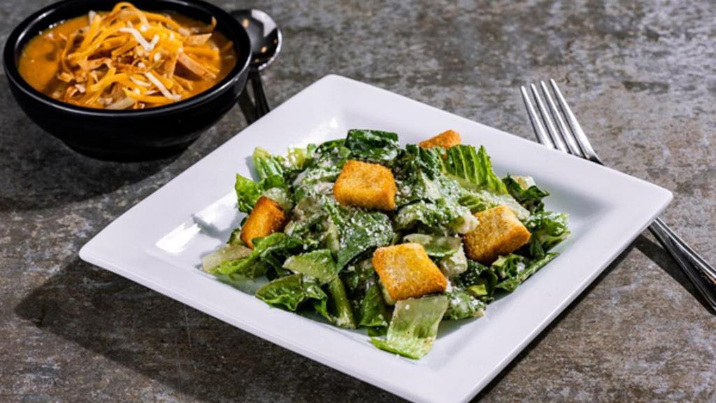 Soup & Caesar Salad · A delicious bowl of Soup with a Caesar Salad.