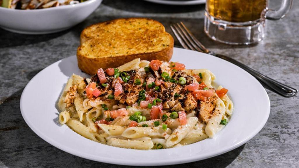 Cajun Chicken Pasta · Grilled chicken, penne in Alfredo sauce, topped with chile spices, Parmesan, tomatoes, green onions. Served with garlic toast.