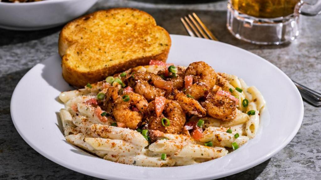 Cajun Shrimp Pasta · Shrimp, penne in Alfredo sauce, topped with chile spices, Parmesan, tomatoes, green onions. Served with garlic toast.