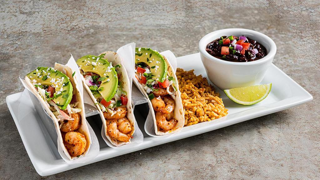Spicy Shrimp Tacos · Three spicy chile-lime shrimp tacos in flour tortillas with pico, avocado, cilantro, coleslaw queso fresco. Served with Mexican rice & black beans.
