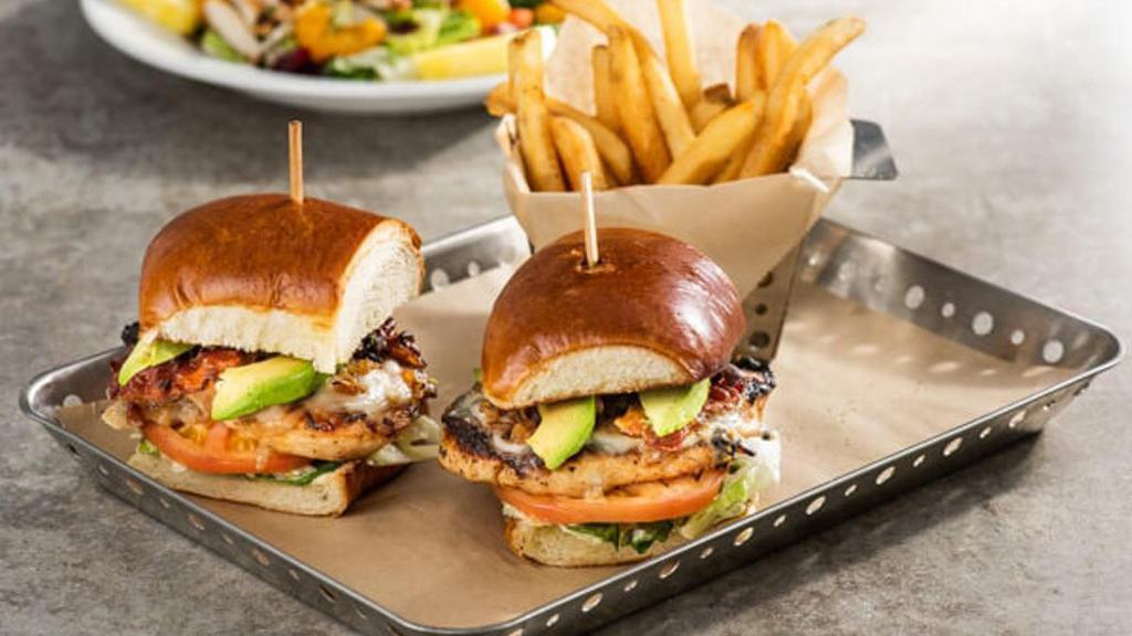 Bacon Avocado Grilled Chicken Sandwich · You definitely won't be hungry later. Grilled chicken, bacon, swiss, avocado, sauteed onions, lettuce, tomato, cilantro-pesto mayo on a toasted buttery roll.
