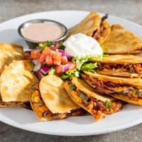 Brisket Quesadillas · Shredded cheese, slow-smoked pulled brisket, roasted jalapeños, house BBQ. Served with pico,...