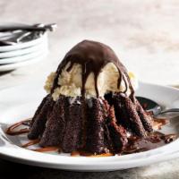 Molten Chocolate Cake · Chocolate cake with a molten chocolate center, topped with vanilla ice cream in a chocolate ...