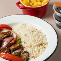 Lomo Saltado Tenderloin · A chinese tenderloin beef stir fry with a Peruvian twist. Comes with sauteed tomatoes, red o...
