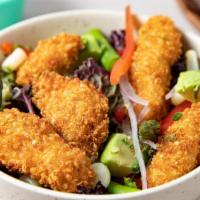 Quinoa Chicken Tenders Salad · Quinoa crusted chicken breast on a bed of romaine lettuce, with giant corn, red spring onion...
