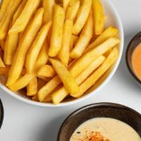 French Fries Portion · A 14-ounce side of crispy fries with your choice of 2 signature sauces: yellow chili, spicy ...
