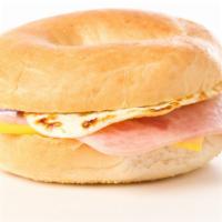 Ham, Eggs & Cheese Breakfast Bagel · Sliced ham, cheese and two eggs garnished on a delectable bagel.